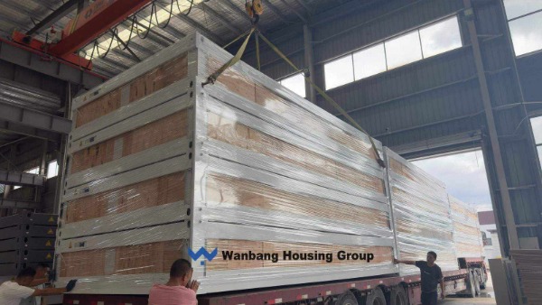Flat pack container houses being loaded into a 40ft container at a Chinese factory &mdash; packing efficiency determines freight cost per unit